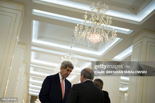 Secretary of State John Kerry and Uzbek Foreign Minister Abdulaziz Kamilov talk before a meeting with Uzbek President Islam Karimov at the Palace of...