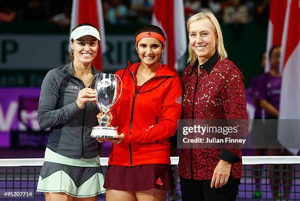 Martina Navratilova poses with Martina Hingis of Switzerland and Sania Mirza of India as they hold up the Martina Navratilova Doubles Trophy after...