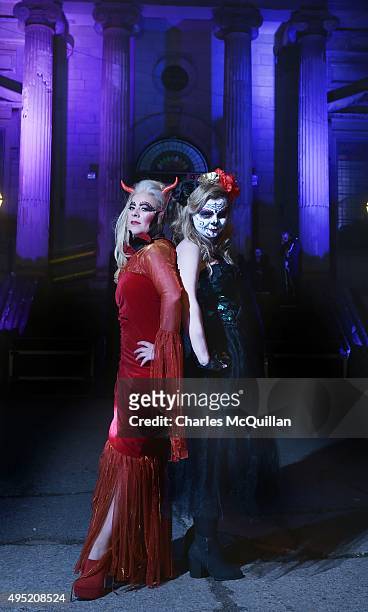 Revellers pose for photographs as they arrive for a Gothic Ball taking place inside a former church on October 31, 2015 in Londonderry, Northern...