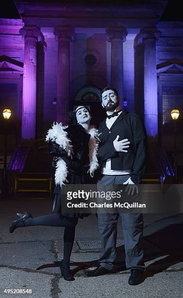Revellers dressed as black and white movie stars pose for photographs as they arrive for a Gothic Ball taking place inside a former church on October...