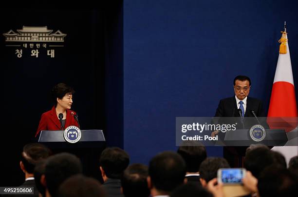 South Korean President Park Geun-Hye looks at Chinese Premier Li Keqiang while speaking during a joint news conference at the presidential Blue House...