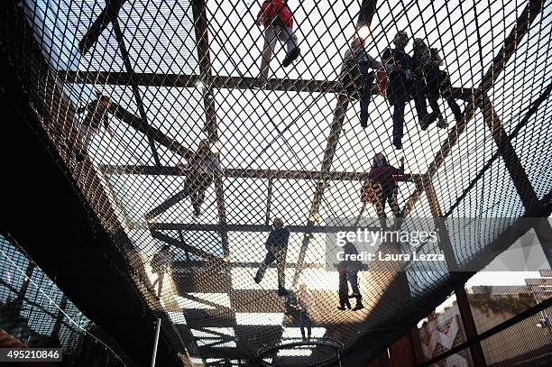 People walk on the net inside the Brazil Pavillon during the closing day of the exh ibition on October 31, 2015 in Milan, Italy.The gates of the...