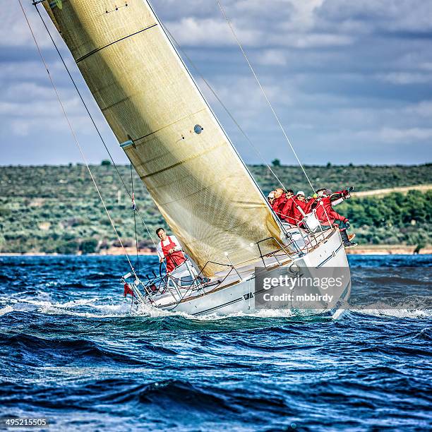 sailing crew on sailboat during regatta - race unity stock pictures, royalty-free photos & images