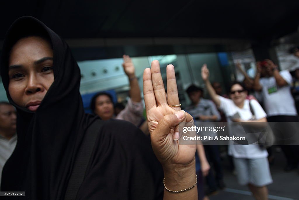 Protester raise three fingers representing liberty,...