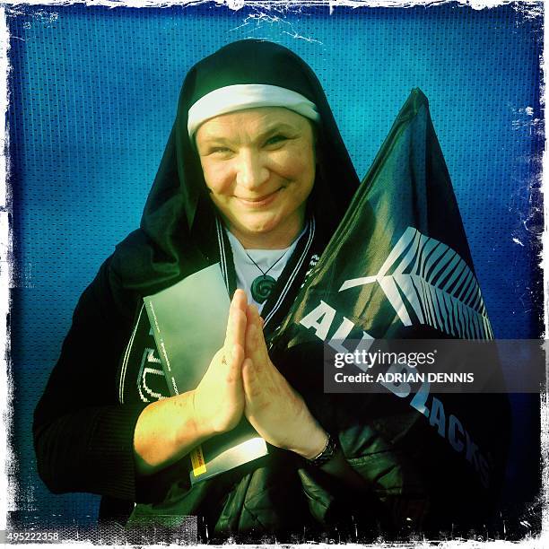 Photo taken with a mobile phone shows New Zealand rugby fan "Wendy" pose for a photograph ahead of the final match of the 2015 Rugby World Cup...