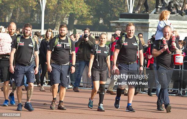 Prince Harry meets with members of the Walking With The Wounded team in the forecourt of Buckingham Palace after their latest endeavour, the Walk Of...