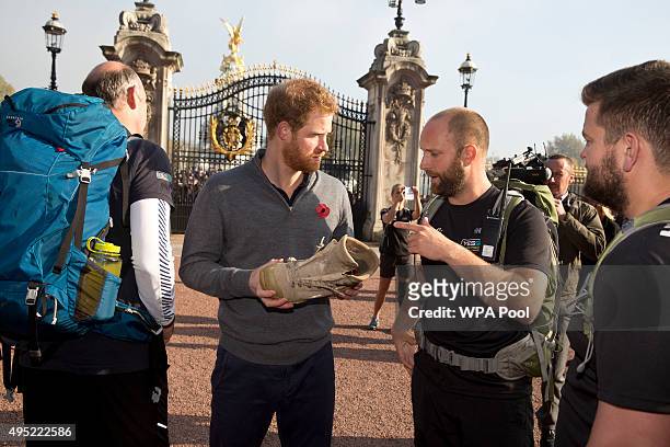 Prince Harry meets with members of the Walking With The Wounded team in the forecourt of Buckingham Palace after their latest endeavour, the Walk Of...
