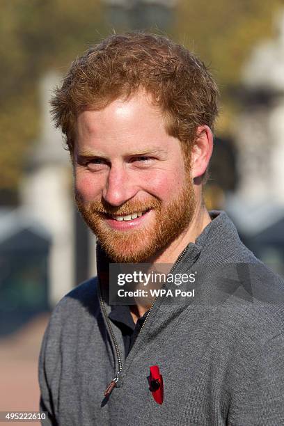 Prince Harry meets with members of the Walking With The Wounded team in the forecourt of Buckingham Palace after their latest endeavour, the Walk Of...