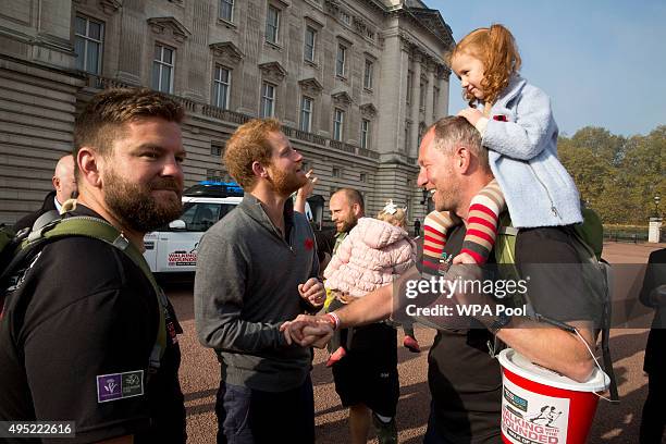 Prince Harry meets with members of the Walking With The Wounded team in the forecourt of Buckingham Palace after their latest endeavour, the Walk Of...