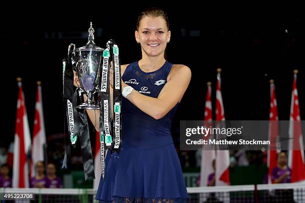 Agnieszka Radwanska of Poland holds the Billie Jean King Trophy after defeating Petra Kvitova of Czech Republic in the final match during the BNP...