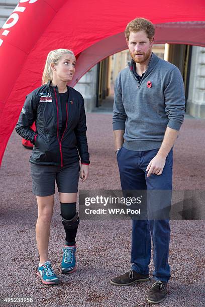 Prince Harry speaks with Kirsty Ennis , a helicopter door gunner and Afghan veteran as he meets with members of the Walking With The Wounded team in...