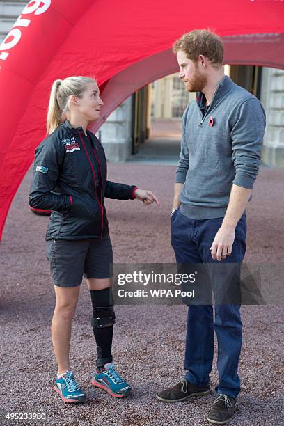 Prince Harry speaks with Kirsty Ennis , a helicopter door gunner and Afghan veteran as he meets with members of the Walking With The Wounded team in...