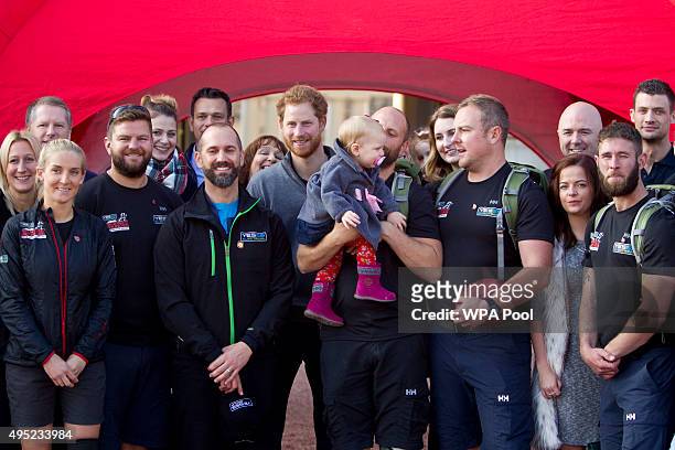 Prince Harry poses with members of the Walking With The Wounded team in the forecourt of Buckingham Palace after their latest endeavour, the Walk Of...