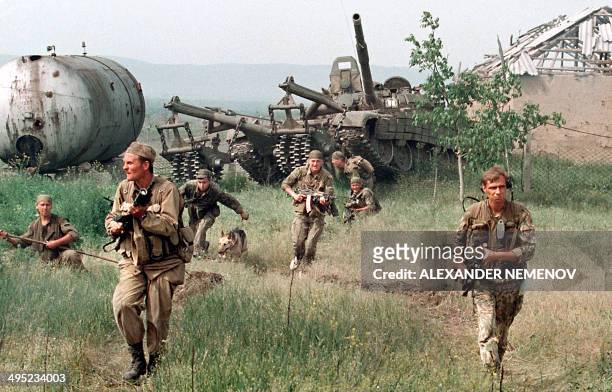 Members of the Russian Army "special forces", followed by a tank, enter in May 1996 in the Chechen stronghold of Bamut, a village in western Chehnya,...