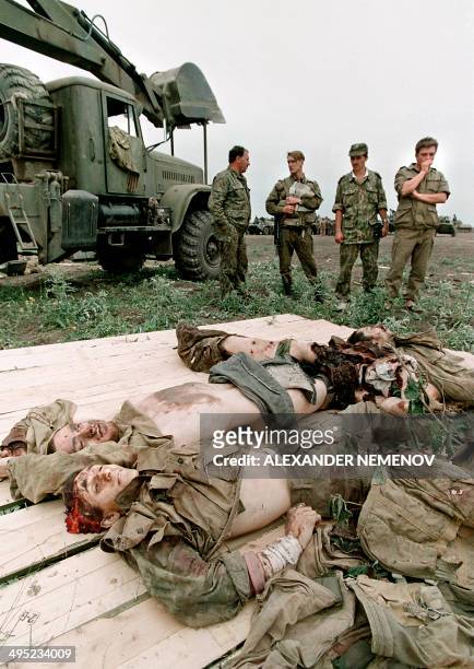 Members of the Russian Army "special forces" look at the bodies of Chechen fighters in May 1996 in the Chechen stronghold of Bamut, a village in...