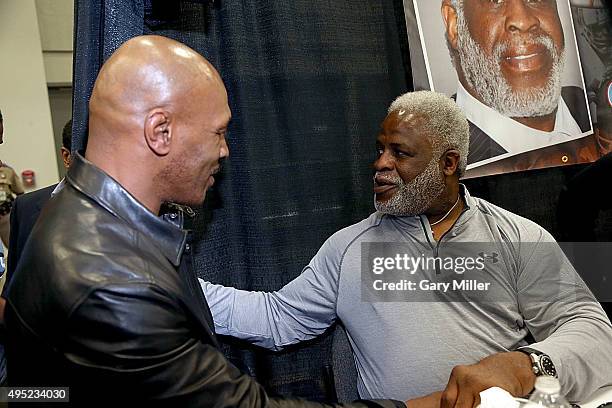 Mike Tyson speaks with Earl Campbell during the Wizard World Comic Con Austin at the Austin Convention Center on October 31, 2015 in Austin, Texas.