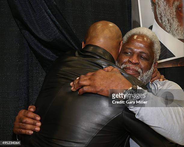 Mike Tyson speaks with Earl Campbell during the Wizard World Comic Con Austin at the Austin Convention Center on October 31, 2015 in Austin, Texas.
