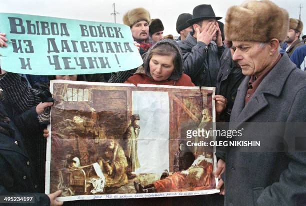 Chechen civilians from Dagestan villages near the Chechen border gather on the road to the blocked village of Pervomaiskaya to demonstrate against...