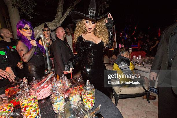 Musician Mariah Carey fills a bag of treats from Sugar Factory Food and Candy at Mariah Carey's Festive Halloween Party at her Beverly Hills Airbnb...