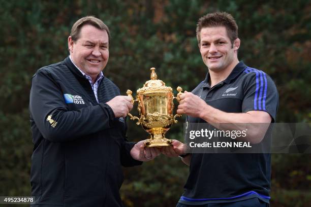 New Zealand's flanker and captain Richie McCaw and New Zealand's head coach Steve Hansen pose for a photograph with the Webb Ellis Cup as they arrive...