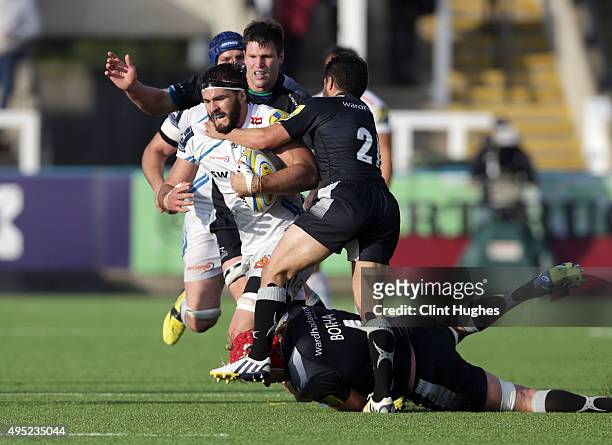 Ruki Tipuna and Mouritz Botha of Newcastle Falcons tackle Don Armand of Exeter Chiefs during the Aviva Premiership match between Newcastle Falcons...