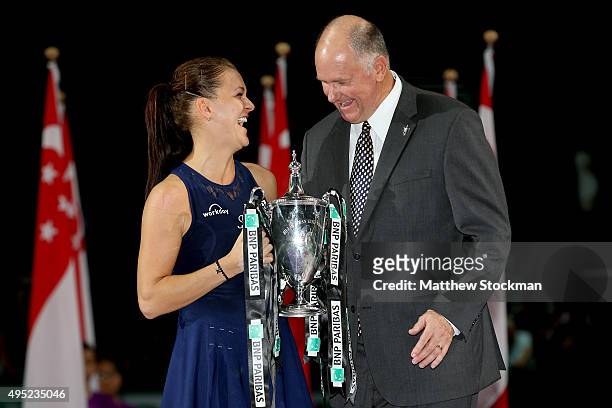 Steve Simon poses with Agnieszka Radwanska of Poland holding the Billie Jean King Trophy after defeating Petra Kvitova of Czech Republic in the final...