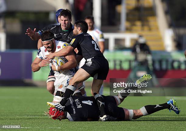 Ruki Tipuna and Mouritz Botha of Newcastle Falcons tackle Don Armand of Exeter Chiefs during the Aviva Premiership match between Newcastle Falcons...