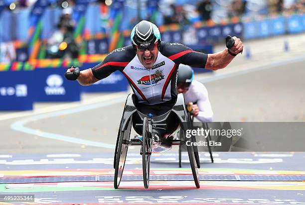 Ernst van Dyk of South Africa celebrates as he crosses the finish line to win the Professional Wheelchair Division during the 2015 TCS New York City...