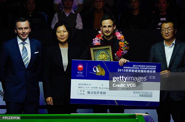 David Gilbert of England poses with a garland after the final match against John Higgins of Scotland on day 8 of Snooker International Championship...