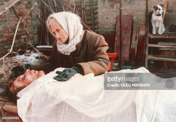 Mother weeps beside the body of her son in the shattered Chechen town of Gudermes 27 December 1995 killed in the battle between Russia Russian Army...