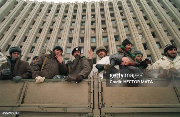 Chechen volunteers on a truck prepare to go to the front line on December 22, 1994 in front of the presidential palace in Grozny city. Russian...