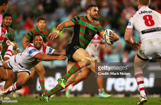 Greg Inglis of the Rabbitohs makes a line break as Benji Marshall of the Dragons falls off the tackle during the round 12 NRL match between the South...