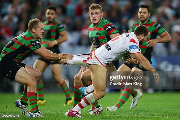 Jason Nightingale of the Dragons is tackled by the pants by Jason Clark of the Rabbitohs during the round 12 NRL match between the South Sydney...