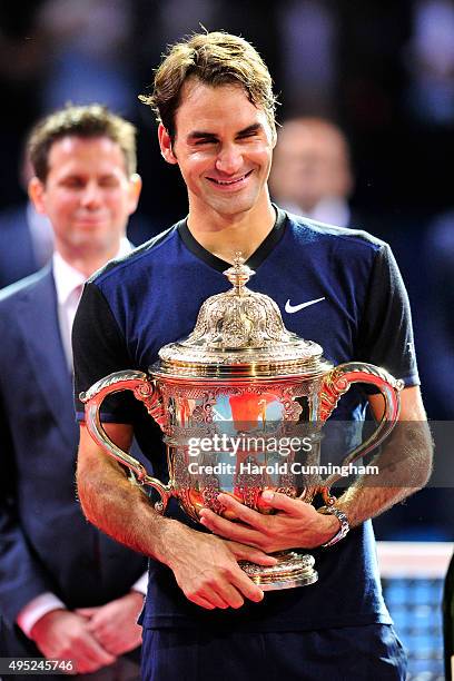 Roger Federer of Switzerland celebrates his victory with the trophy after the Swiss Indoors ATP 500 Final against Rafael Nadal of Spain at St...