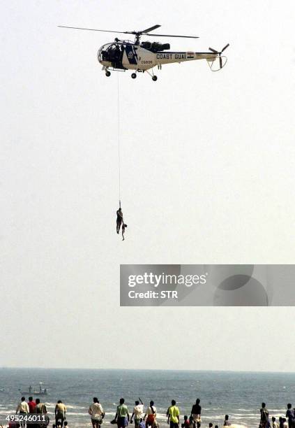 An Indian coast guard helicopter takes part in rescue operations in Madras, 26 December 2004, after tidal waves hit the region. Tidal waves...