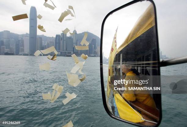 Hong Kong buddhist prays and throws paper money in the sea during a ceremony to "free the spirit of tsunami victims", in Hong Kong 30 December 2004....