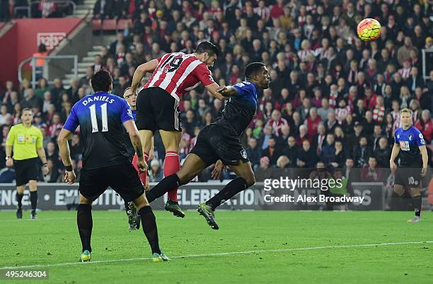 Graziano Pelle of Southampton outjumps Sylvain Distin of Bournemouth to score their second goal during the Barclays Premier League match between...