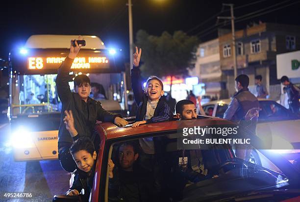 Children make victory signs as supporters of Turkey's pro-Kurdish People's Democratic Party celebrate in the southeastern city of Diyarbakir after...