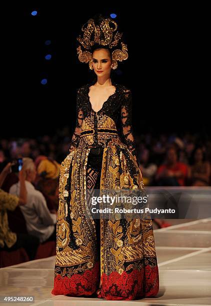 Model showcases designs by Anne Avantie at the Merenda Kasih show during her 25th anniversary as a fashion designer at Pakuwon Imperial Ballroom on...