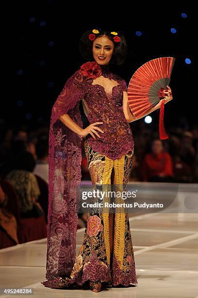 Model showcases designs by Anne Avantie at the Merenda Kasih show during her 25th anniversary as a fashion designer at Pakuwon Imperial Ballroom on...