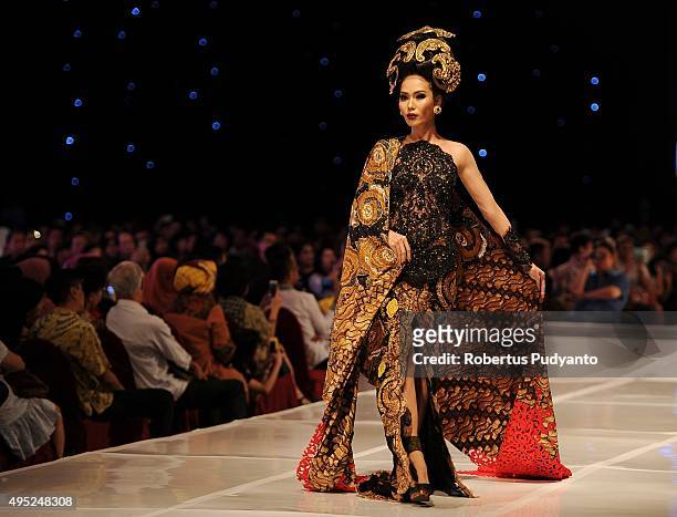 Model showcases designs by Anne Avantie at the Merenda Kasih show during her 25th anniversary as a fashion designer at Pakuwon Imperial Ballroom on...
