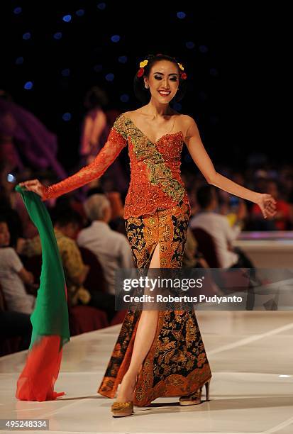 Model showcases designs by Anne Avantie at the Merenda Kasih show during her 25th anniversary as a fashion designer at Pakuwon Imperial Ballroom on...
