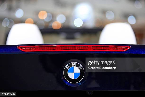 The BMW logo sits on the rear of a BMW M3 Cabrio automobile, produced by Bayerische Motoren Werke AG , at the company's stand at the Auto Mobil...