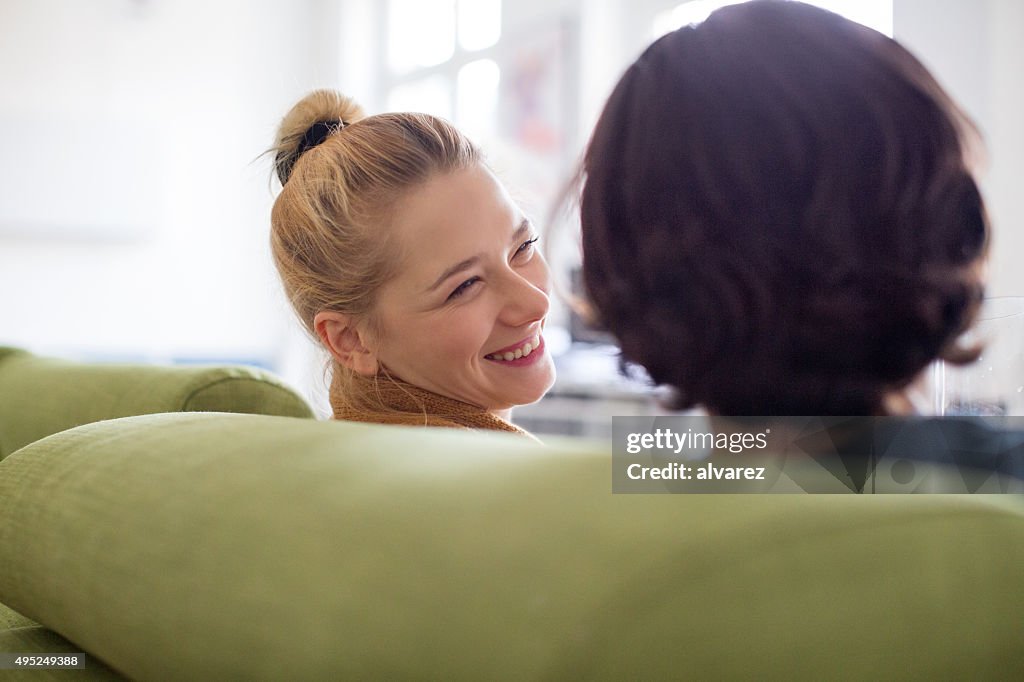 Happy young couple sitting on sofa