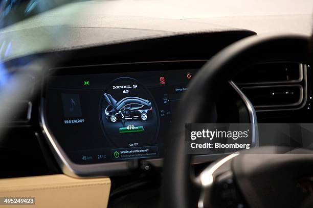 The dashboard sits illuminated inside aTesla S 85 electric automobile, manufactured by Tesla Motors Inc., at the Auto Mobil International automotive...