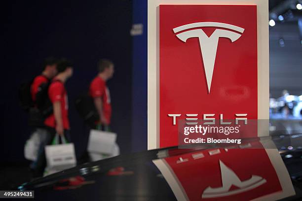 The logo of Tesla Motors Inc. Sits on a sign on the manufacturer's stand at the Auto Mobil International automotive trade fair, at Leipziger Messe in...