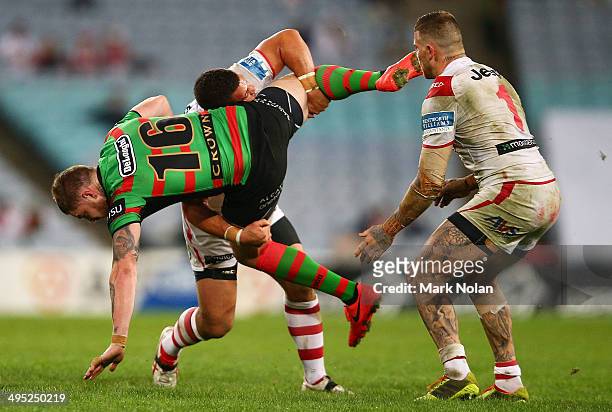Chris McQueen of the Rabbioths is tackled by Bronson Harrison of the Dragons during the round 12 NRL match between the South Sydney Rabbitohs and the...