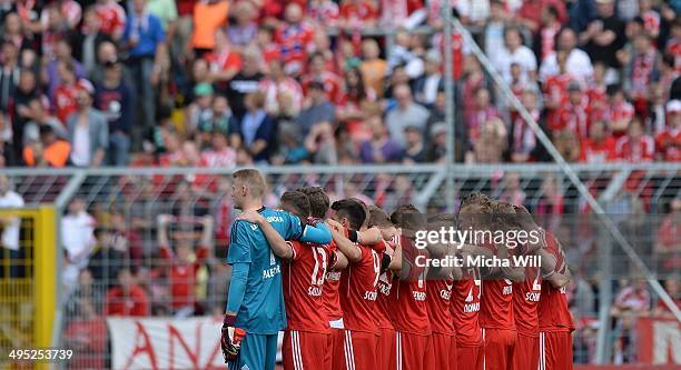 Muenchens players are seen during a moment of silence during the second relegation leg between Bayern Muenchen II and Fortuna Koeln at Stadion An Der...