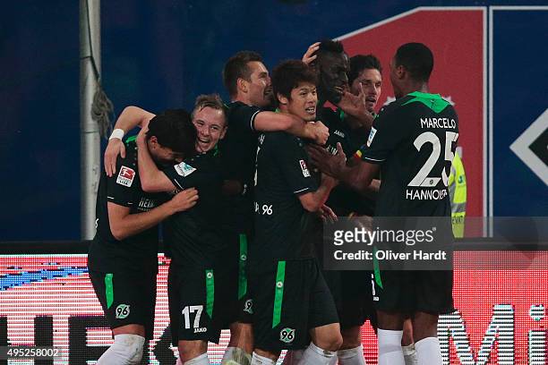 Salif Sane of Hannover celebrates with teammates after heading his team's first goal during the First Bundesliga match between Hamburger SV and...