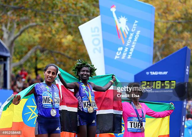 Second place winner Aselefech Mergia of Ethiopia, first place winner Mary Keitany of Kenya and third place winner Tigist Tufa of Ethiopia pose with...